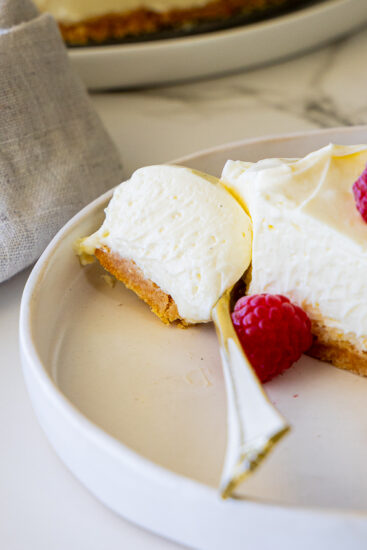 Creamy No-bake cheesecake on serving plate with fork.