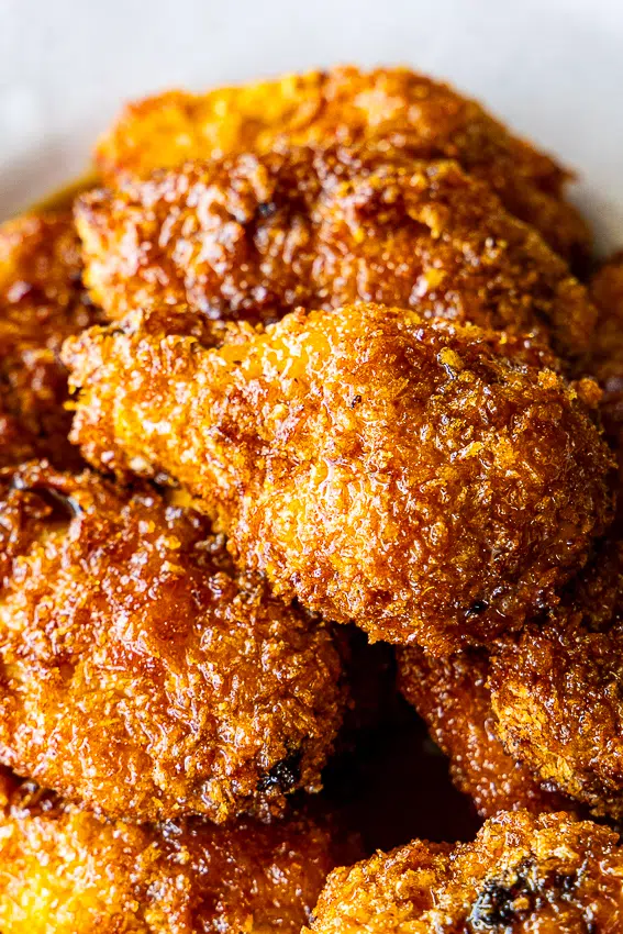 Crispy coated chicken wings coated in sticky sauce.