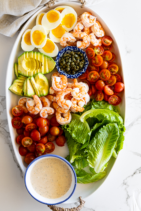 Shrimp Louie salad with boiled eggs, avocado, tomatoes and capers