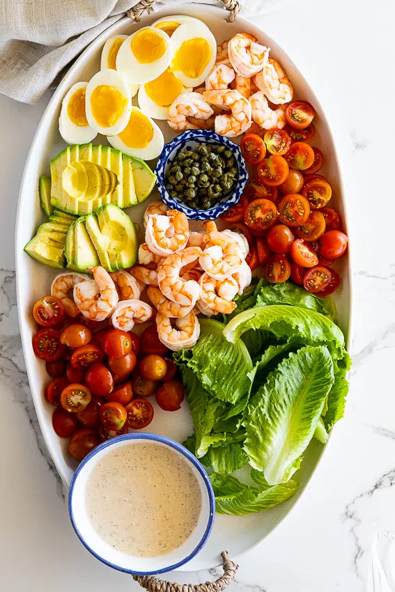 Shrimp Louie salad with boiled eggs, avocado, tomatoes and capers