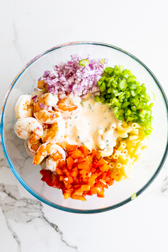Ingredients for shrimp pasta salad in a bowl.