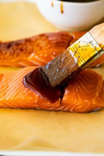 Teriyaki sauce brushed over salmon.
