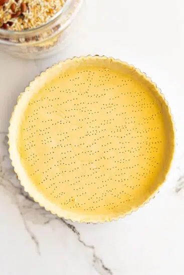 Docked pastry crust for quiche.