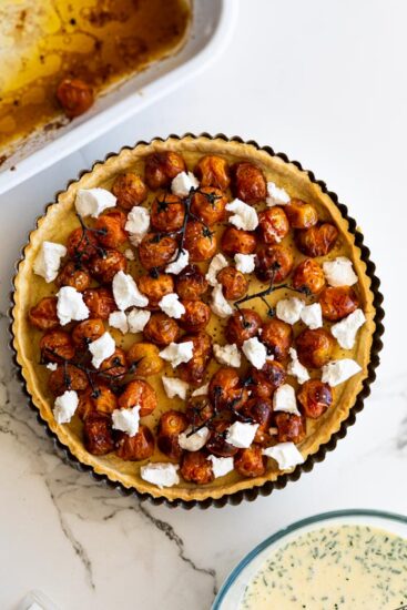 Quiche crust with roasted cherry tomatoes and soft goat cheese..