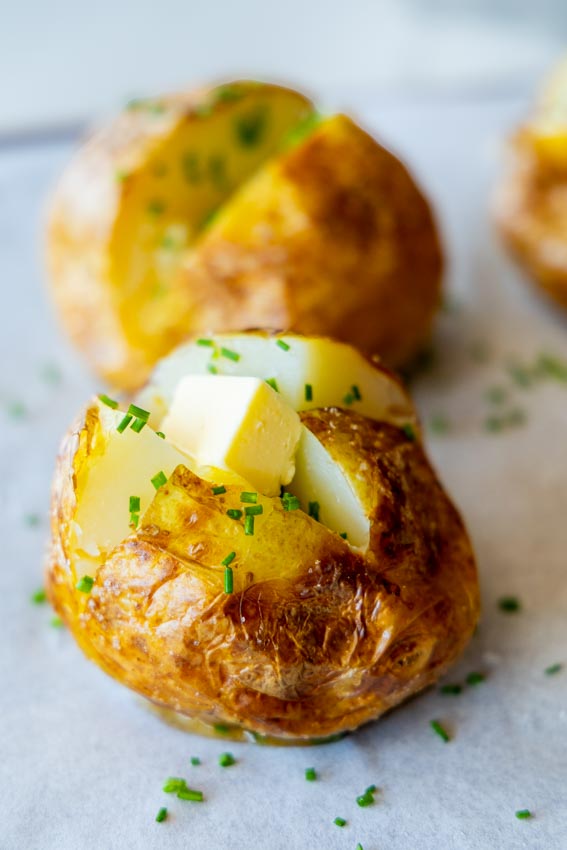 Air fryer baked potato with butter.