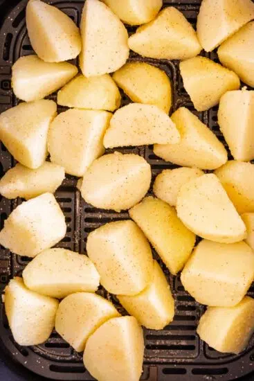 Chopped potatoes in air fryer basket
