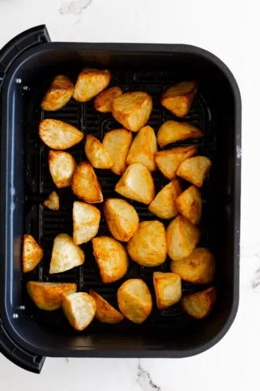 Roasted potatoes in air fryer basket.