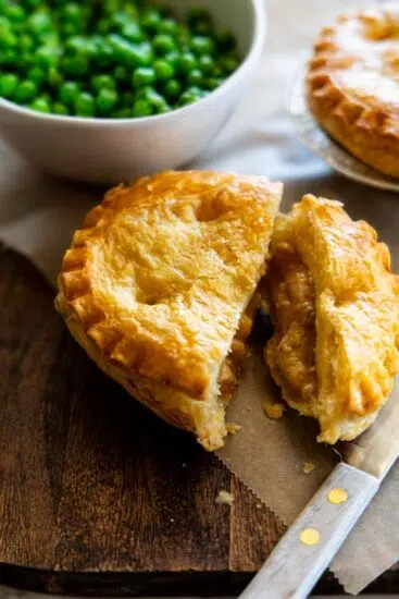 Chicken pie cooked in the air fryer served with peas.