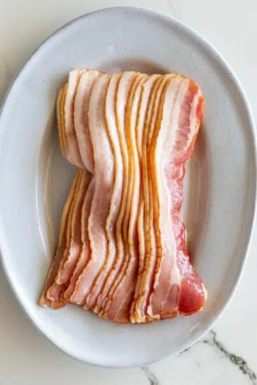 Raw bacon on plate
