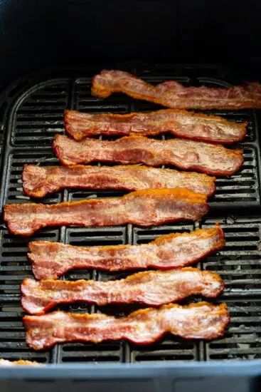 Cooked bacon in air fryer basket