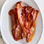 Crispy air fryer bacon on serving plate