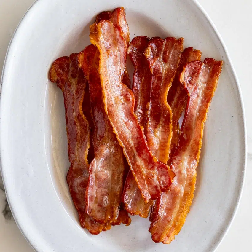 Crispy air fryer bacon on serving plate