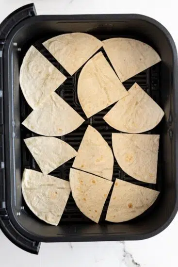 Tortilla chips in air fryer basket