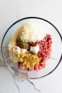 Ingredients for air fryer meatballs in a mixing bowl.