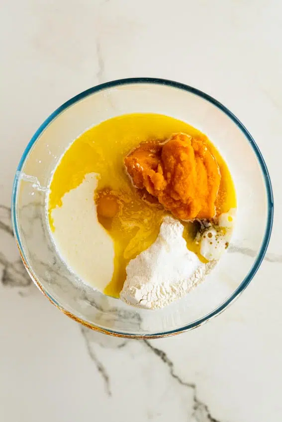 Ingredients for pumpkin pancakes in mixing bowl.