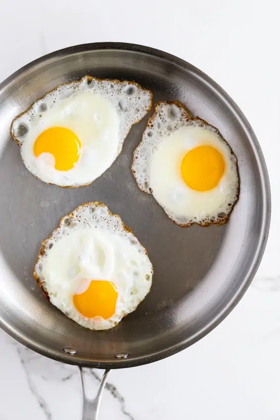 Fried eggs in stainless steel pan