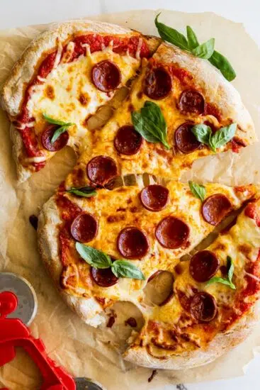 Air fryer pizza with pepperoni and basil.