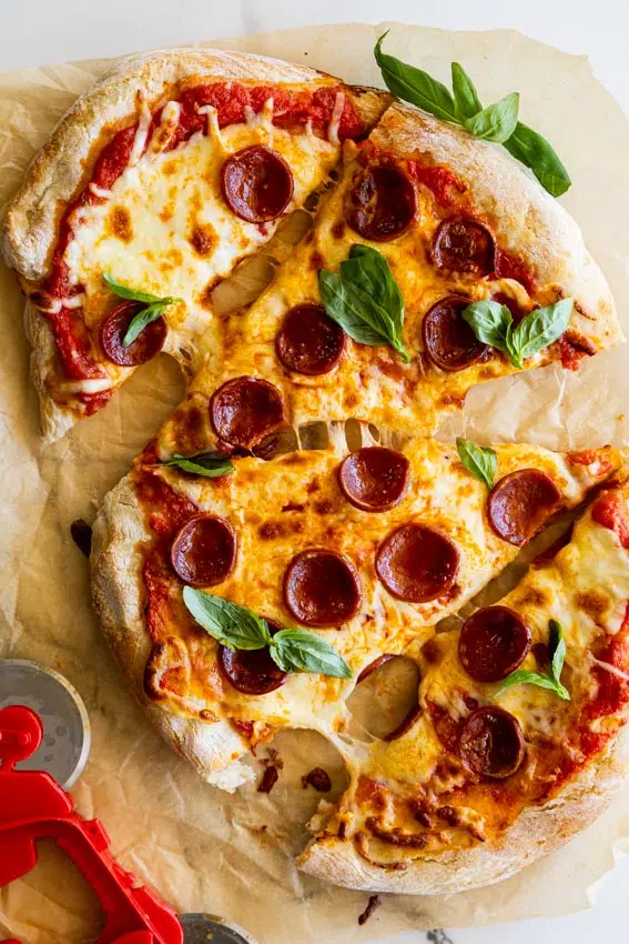 Air fryer pizza with pepperoni and basil.
