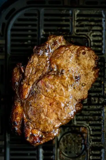 Air fried steak in air fryer basket.