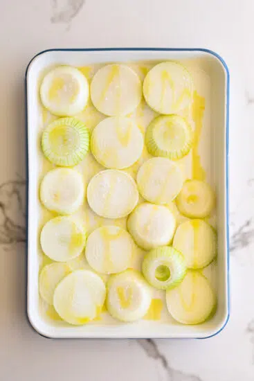 Sliced onions in baking dish.