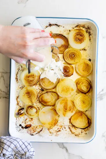 Creamy parmesan sauce poured over baked onions.