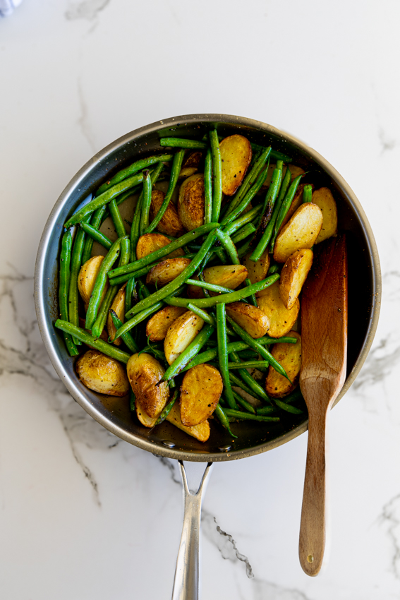 Sautéed Green Beans and Potatoes in a frying pan.