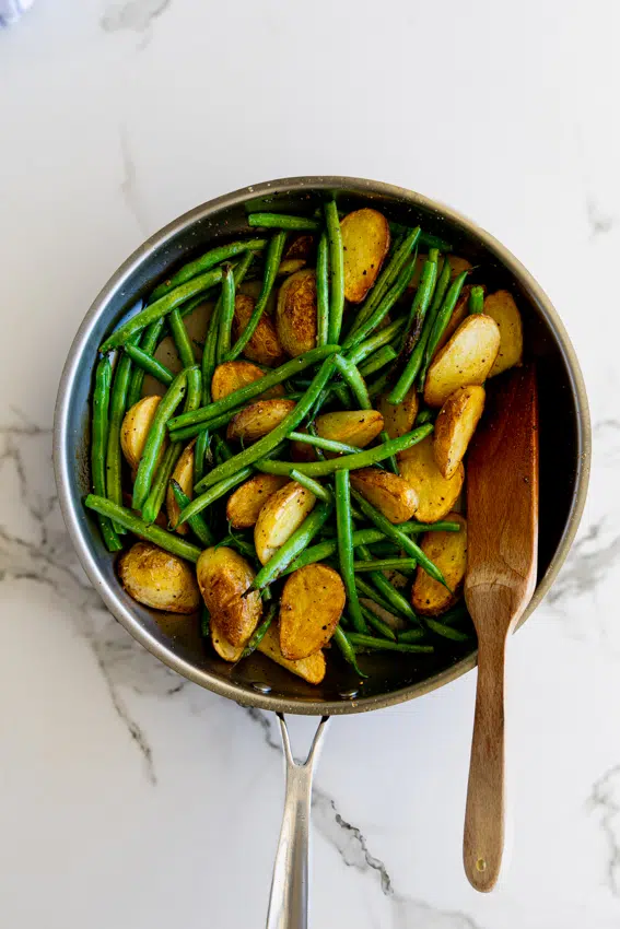 Sautéed Green Beans and Potatoes in a frying pan.