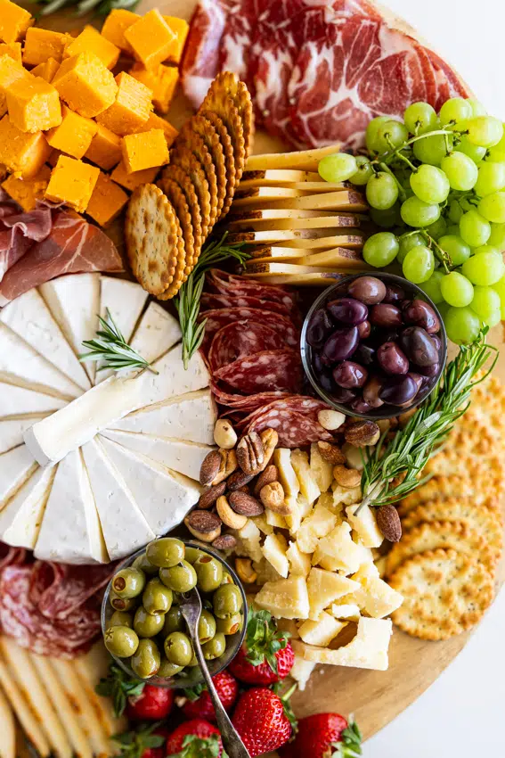 Cheese board with fruit, charcuterie and cheeses