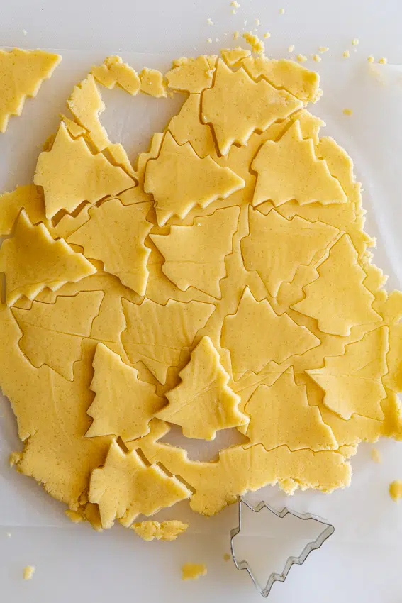 Sugar cookie dough cut into Christmas trees