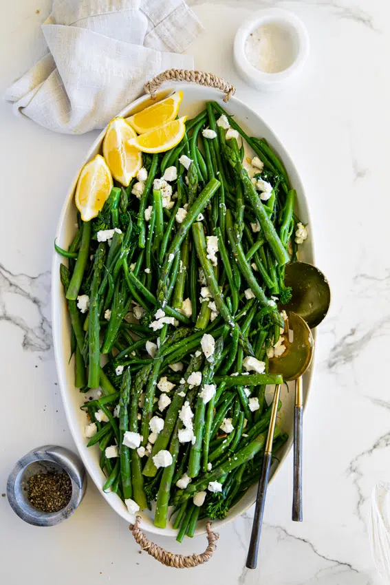 Vegetable Salad with goat cheese and lemon wedges