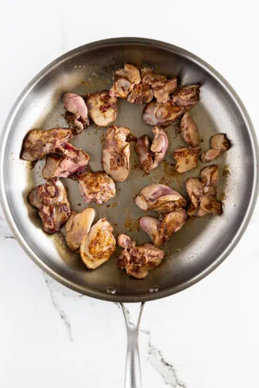 Chicken livers seared in hot pan.