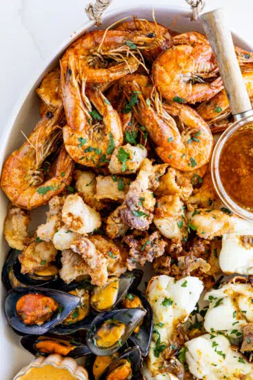 Garlic butter shrimp and fried calamari on seafood platter.