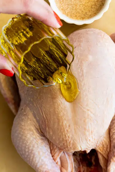 Pour oil over raw chicken.
