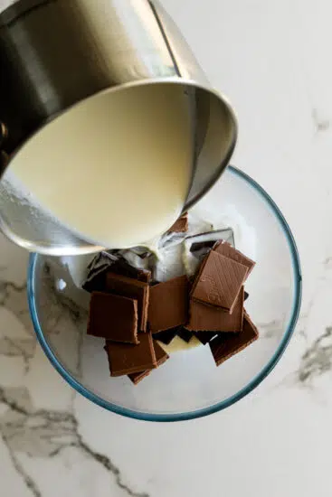 Hot cream poured over chocolate for ganache.