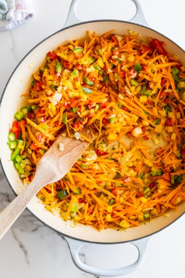 Vevetab;es for Chakalaka cooking in a large pan.