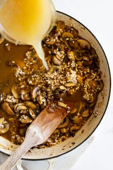 Stock poured into mushroom risotto