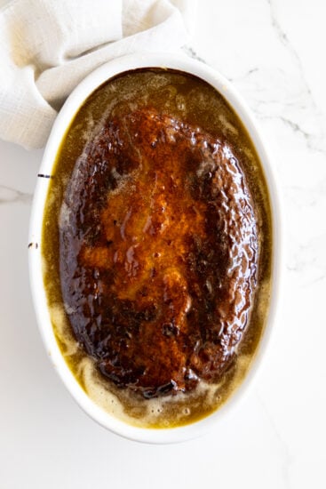 Baked Malva pudding in a white baking dish.