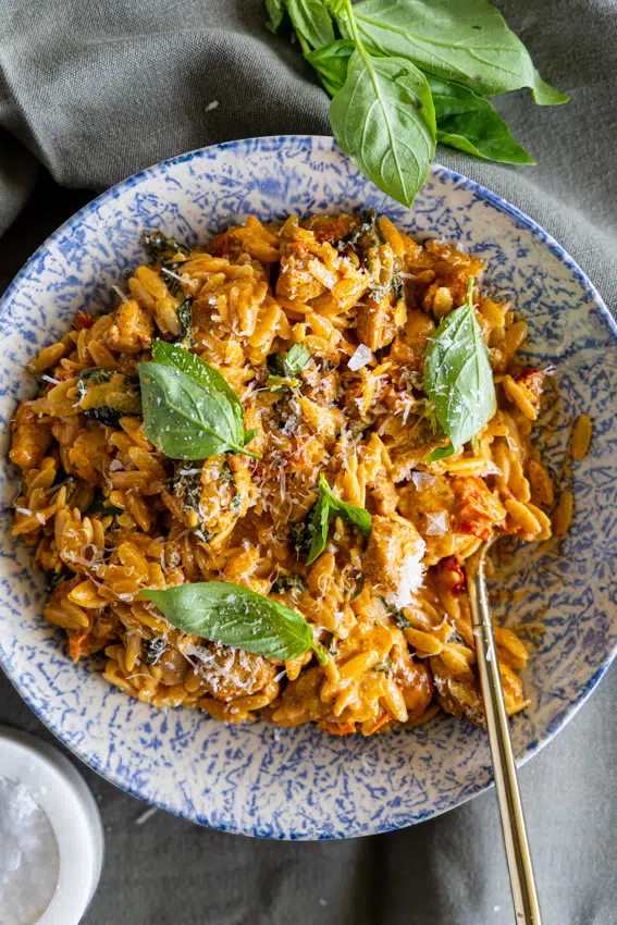 Marry Me Chicken Orzo in bowl with fresh basil