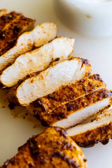 Juicy cooked chicken on a white surface.