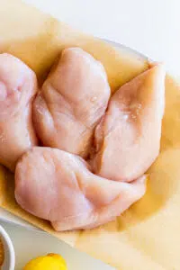 Chicken breasts on a plate.