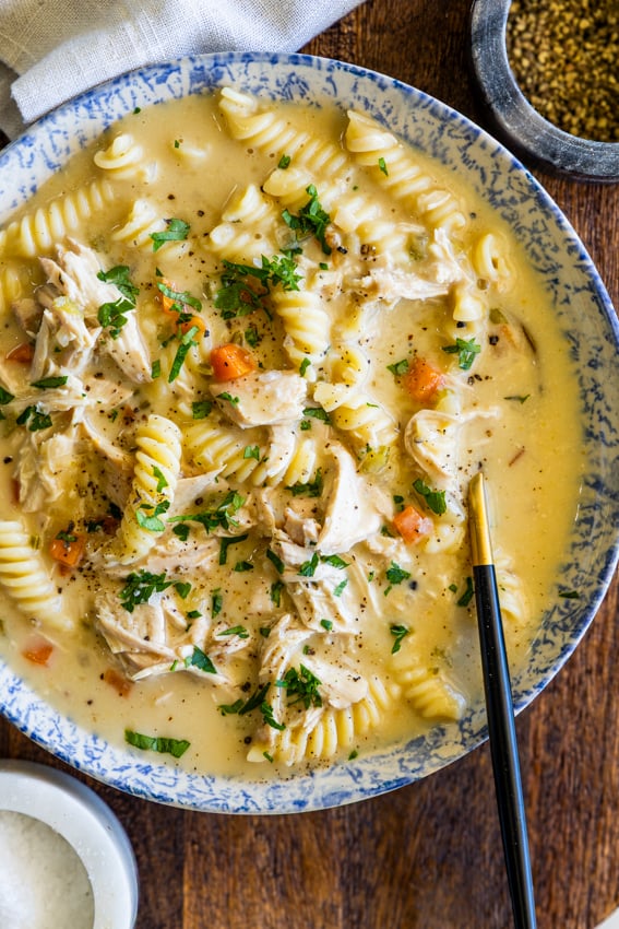 Creamy Chicken Noodle Soup in soup bowl with a spoon.