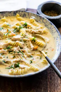 Creamy Chicken Noodle Soup in a serving bowl with soup spoon.