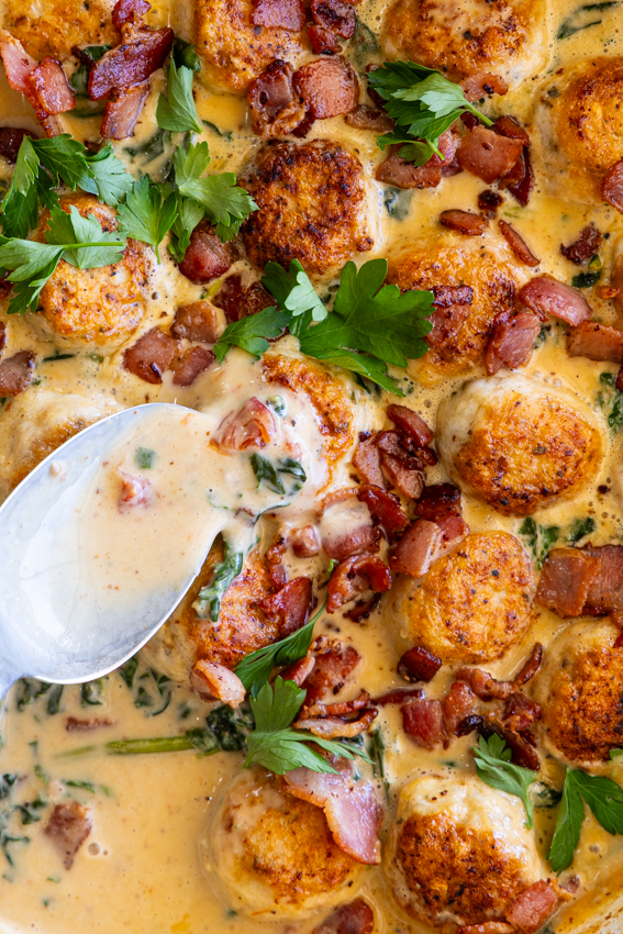 Creamy sauce spooned over chicken meatballs.