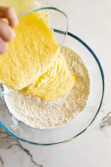 Wet ingredients poured into dry ingredients for plum upside down cake.