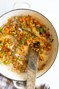 Aromatics sautéed in a large braised.