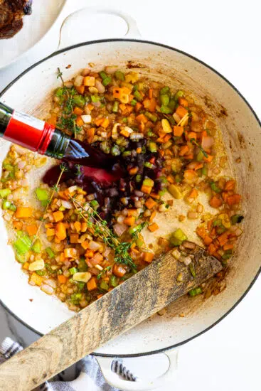 Red wine and aromatics sautéed in a white braiser.