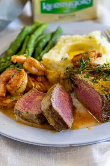 Surf and turf served with asparagus and mashed potatoes.