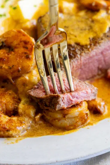 Medium rare filet mignon with shrimp in cream sauce.