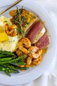 Surf and turf with mashed potatoes and asparagus.