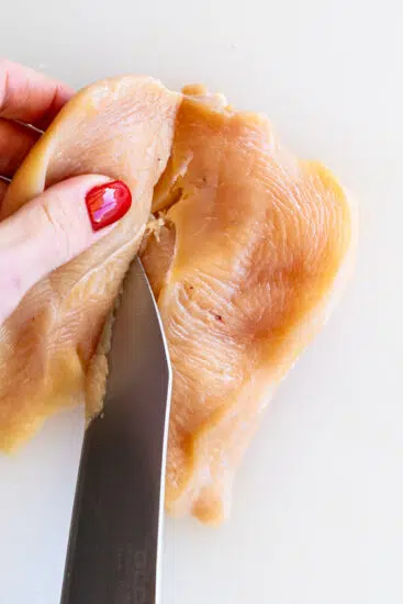 Chicken breasts sliced in half.